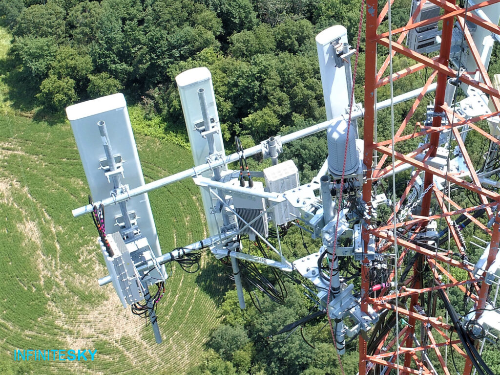 cell tower inspection close up photograph of communication level. Photographed by drone by Infinite Sky Drone Services