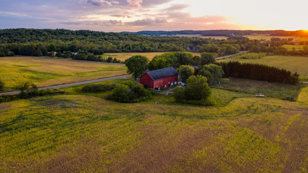 beautiful photo of red barn at sunset